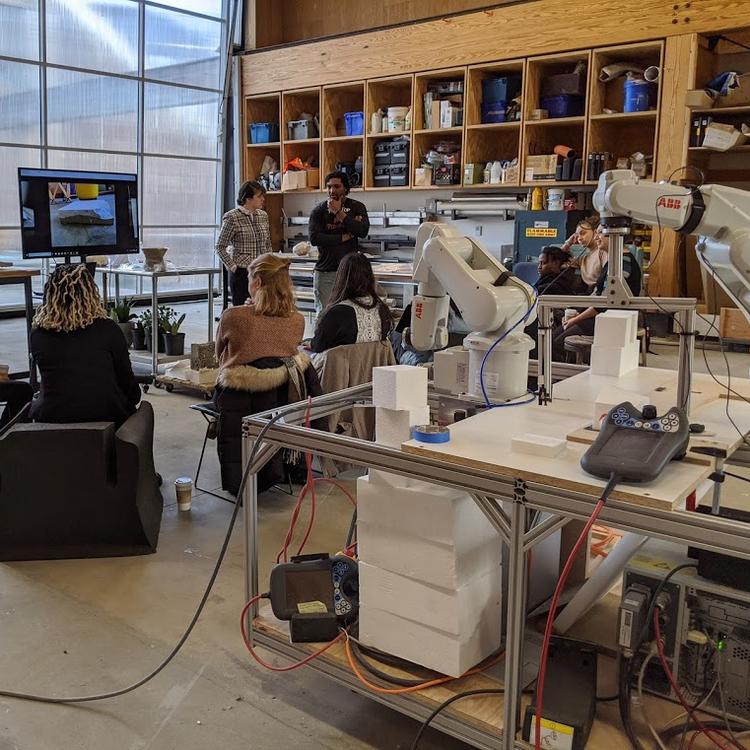 Machine shop with a class learning robotic arms